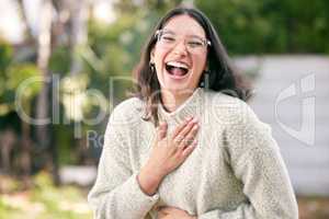 Laughter is medicine for the soul. a happy young woman standing outside.