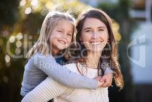 Shes my greatest little blessing. Portrait of a mother and her little daughter bonding together outdoors.