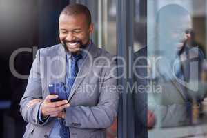 You know how to reach me. a businessman using his cellphone while out in the city.