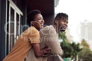 To share a life with you is bliss. an affectionate your couple bonding on a balcony outdoors.