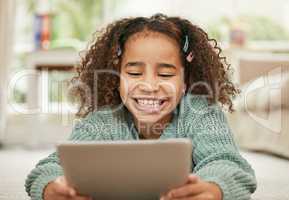 There are many ways of learning now. a little girl using a digital tablet at home.