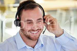 Always a pleasure to hear from you. a young man using a headset in a modern office.