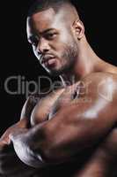 Greatest of all time. Studio portrait of a fit young man posing against a black background.