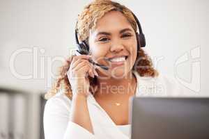 Happy, smiling and friendly call center agent wearing headset while working in an office. Portrait of confident businesswoman consulting and operating helpdesk for customer sales and service support