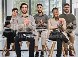 Give life, give love, give soul. Portrait of a group of young businesspeople clapping during a conference in a modern office.