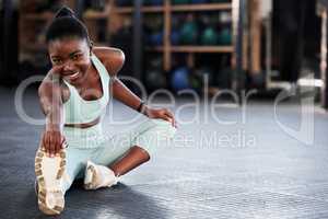 Exercise puts me in a better mood. a fit young woman stretching at the gym.