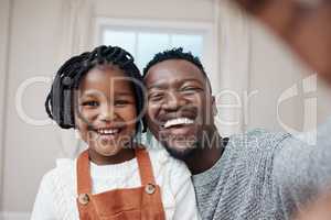 One for the books. a young father bonding with his daughter at home and taking a selfie.