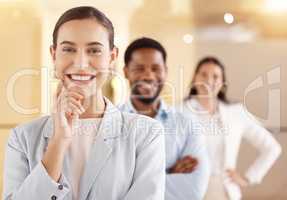 Dedication and hard work will catapult you further. Portrait of a young businesswoman standing in an office with her colleagues in the background.