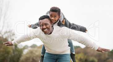 Only the most loved children will soar. Portrait of a father and his son having fun while bonding together outdoors.