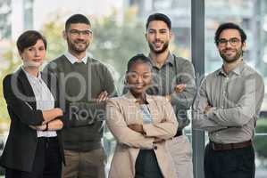 Nicely holding together. Portrait of a group of businesspeople with arms folded at the office.