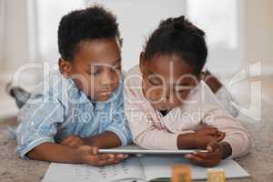 Nurturing their curious minds through educational apps. a little boy and girl using a digital tablet together at home.