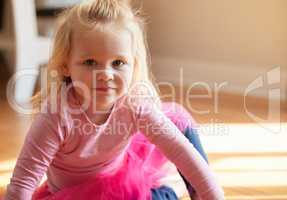 Did I tell you that Im a princess. an adorable little girl sitting on the floor in her bedroom.