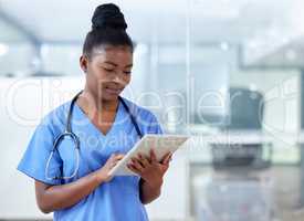 Now I can stay organised. a young female doctor using a digital tablet at work.