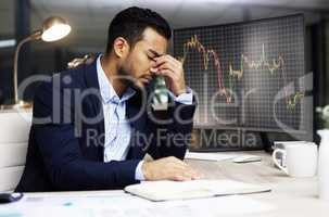 Businessman with depression analysing the stock market and trading during a financial crisis. Stressed trader in a bear market, looking at stocks crashing. Market crash and economy failure