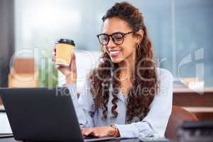 Feeling good about her latest project. an attractive young businesswoman working on her laptop in the office.