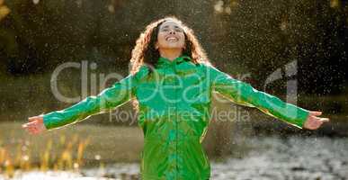 Nothing is more soul cleansing than summer rain. a beautiful young woman having fun in the rain.