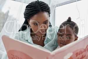 And then what did the princess do... a woman reading a book to her daughter while sitting at home.