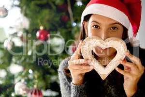 At Christmas play and make good cheer. a young woman holding Christmas decor at home.