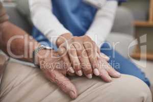 Sometimes all you need is a hand to hold. an unrecognizable nurse holding a patients hand during a checkup at home.