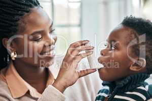 Take a deep breath. a woman helping her son with his inhaler.