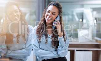 Communication makes everything easier. an attractive young businesswoman making a phonecall while standing in her office.