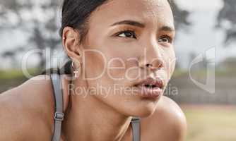 Rest but dont you dare quit. a young woman catching her breath while exercising outdoors.