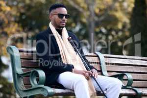 Life is not about finding yourself. a young man sitting on a bench in a park.