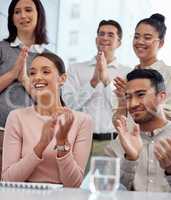 Here to applaud your journey. a group of young businesspeople clapping during a conference in a modern office.