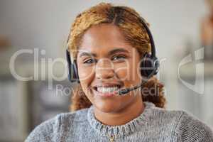 African female call center agent smiling and happy to help in her office at work. Portrait of a young woman customer service employee looking excited and ready to support clients in her workplace