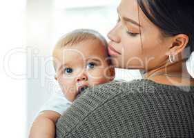 Hes perfect in every sense. a woman holding up her adorable baby boy.