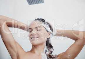 Scalp exfoliation is a key step. a woman washing her hair in the shower.