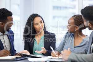 Ideas for success. a group of white collar workers meeting in the boardroom.