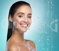 Good hygiene is absolutely essential for our well-being. a young woman washing her hair in the shower against a blue background.