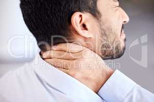 Stress, pain and sore neck closeup of businessman massaging strained muscle. Stressed corporate man suffering from a painful injury rubbing back. Feeling fatigue and unhappy with bad posture