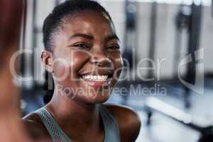 Going to the gym is the best drug. a fit young woman laughing while taking a selfie at gym.