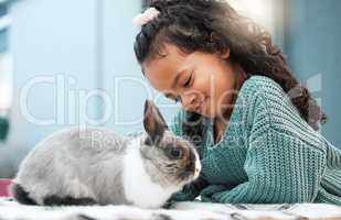 Spending time with my favourite pet. an adorable little girl bonding with her pet rabbit at home.