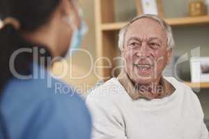 Laughter can cure any disease. an elderly man having a checkup with an unrecognizable nurse at home.