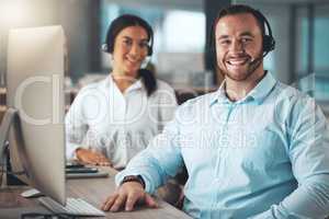 Were the team that solves problems. two young call centre agents sitting together in the office and using a computer.