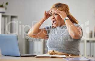 Frustrated, angry, annoyed business woman reading emails on a laptop in a modern office. Young professional worker stressed about a mistake, upset about broken internet connection or pc
