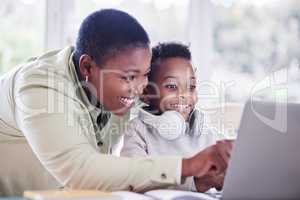 Learn as if you were to live forever. a mother helping her son with his homework at home.