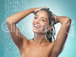 Positive thinking and good hygiene can keep diseases away. a young woman washing her hair in the shower against a blue background.