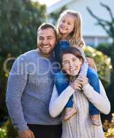 Strong family bonds are essential for a childs development. Portrait of a happy family bonding together outdoors.