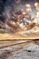 Beach view of sky and clouds at sunset with calm sea water in summer. Nature landscape of a coastline with a cloudy scene over the horizon. Seaside tides and currents on a bright and beautiful day