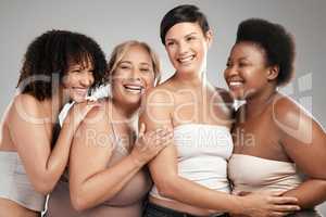 Ageing like fine wine. a diverse group of women standing and hugging each other in the studio.