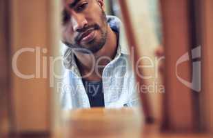 Leave no book unread. a young man choosing a book to read from a library at college.