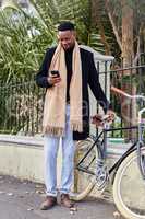 Success is not final, failure is not fatal. a young business man using his cellphone outside.