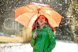 Celebrate the rain and youll be rewarded with the sun. a beautiful young woman having fun in the rain.