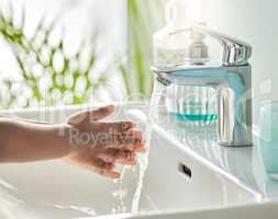 Wash your hands and fingers, to kill any germ that lingers. Closeup shot of an unrecognisable boy washing his hands at a tap in a bathroom at home.