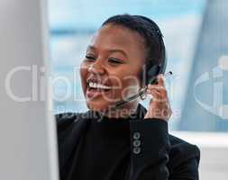 Without customers there is no company. a young woman using a headset and computer.at work in a modern office.