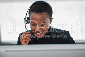 Treat the customer like you would want to be treated. a young woman using a headset and computer.at work in a modern office.